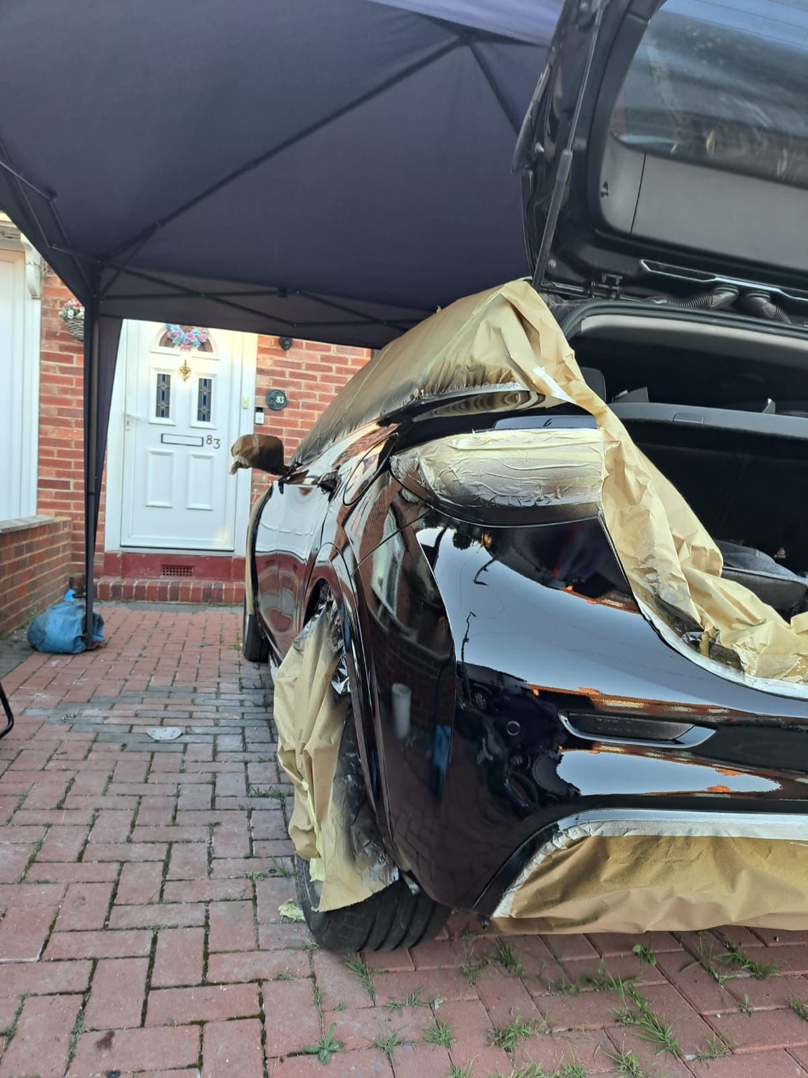Black vehicle rear quarter panel after glossy paint finish