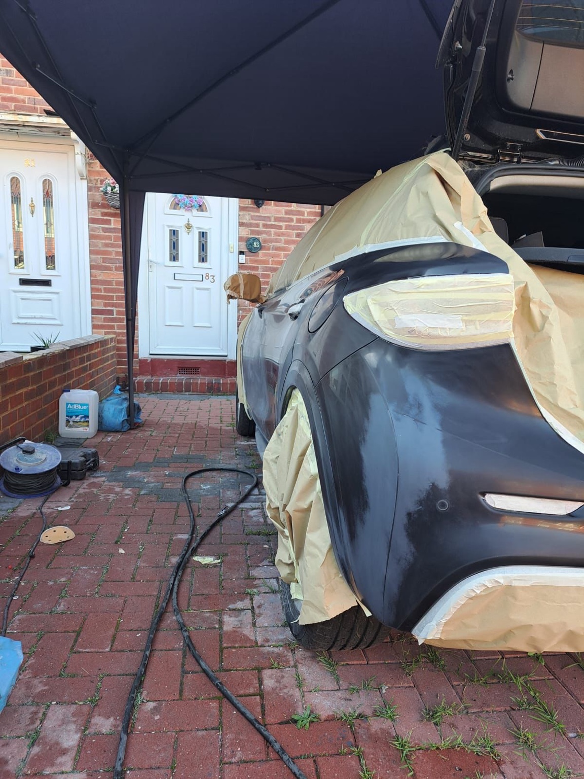 Black vehicle rear quarter area during repair preparation