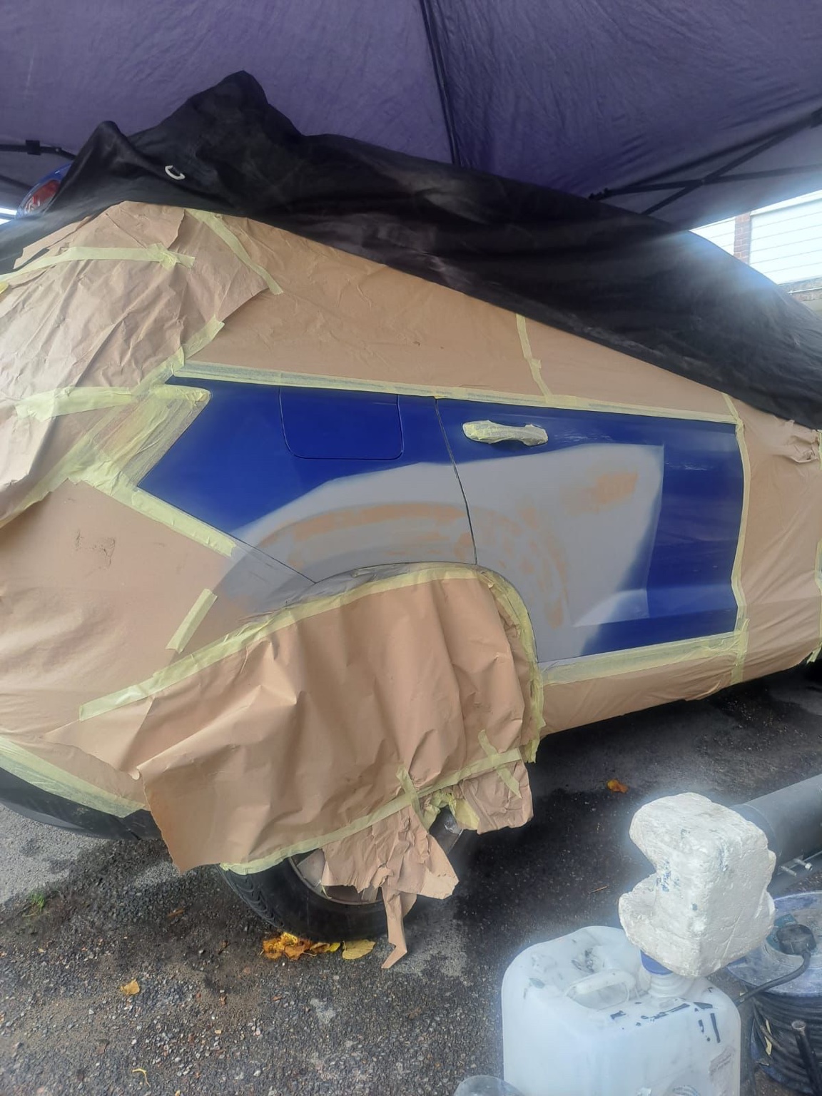 Blue SUV rear quarter panel after repair preparation