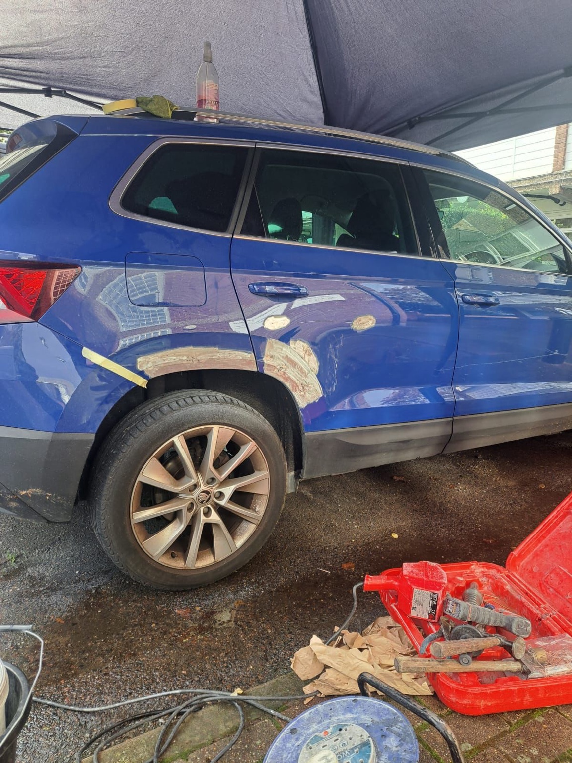 Blue SUV rear quarter panel before bodywork repair