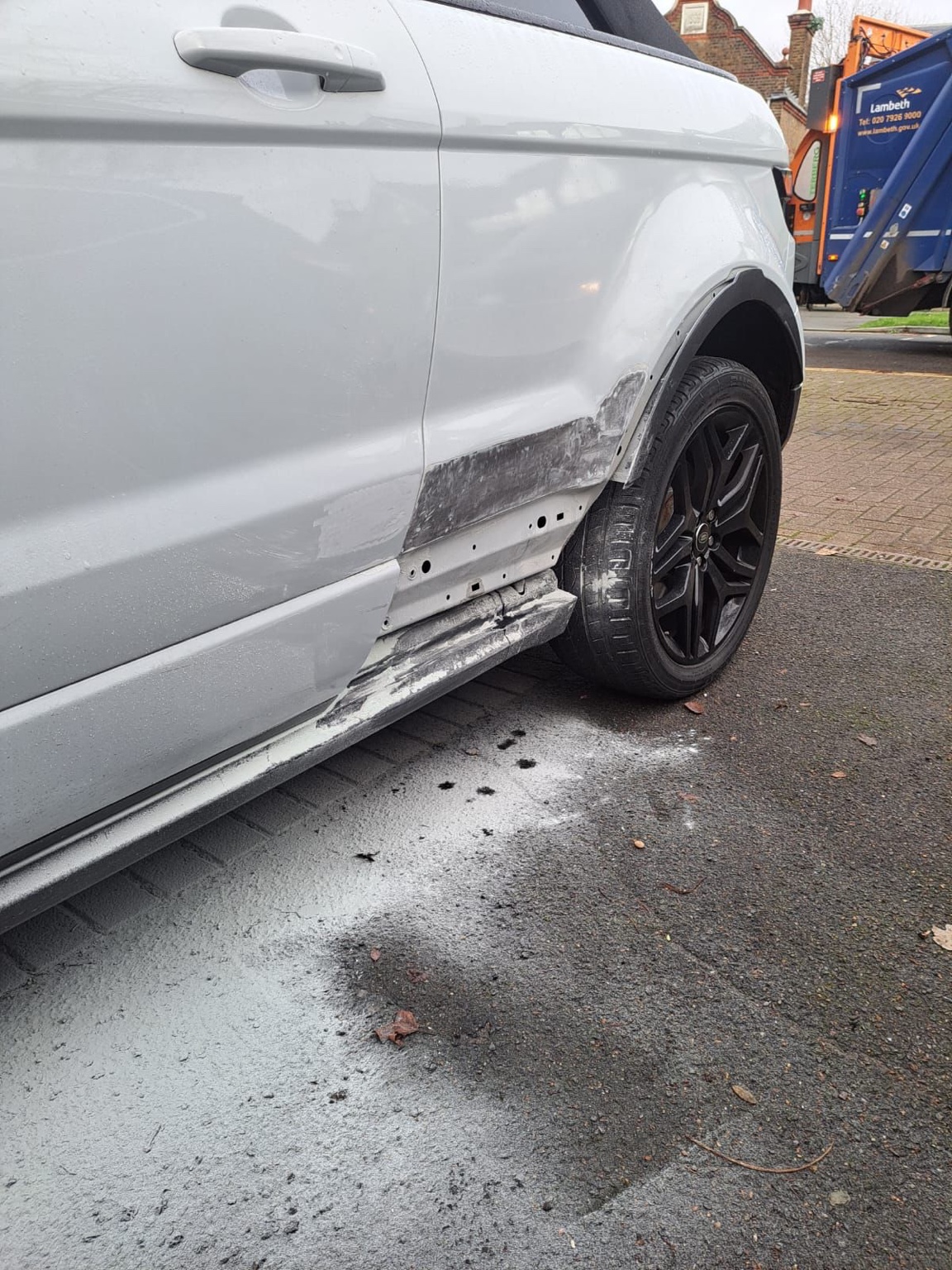 Damaged white Range Rover side panel before repair by BMAT LTD