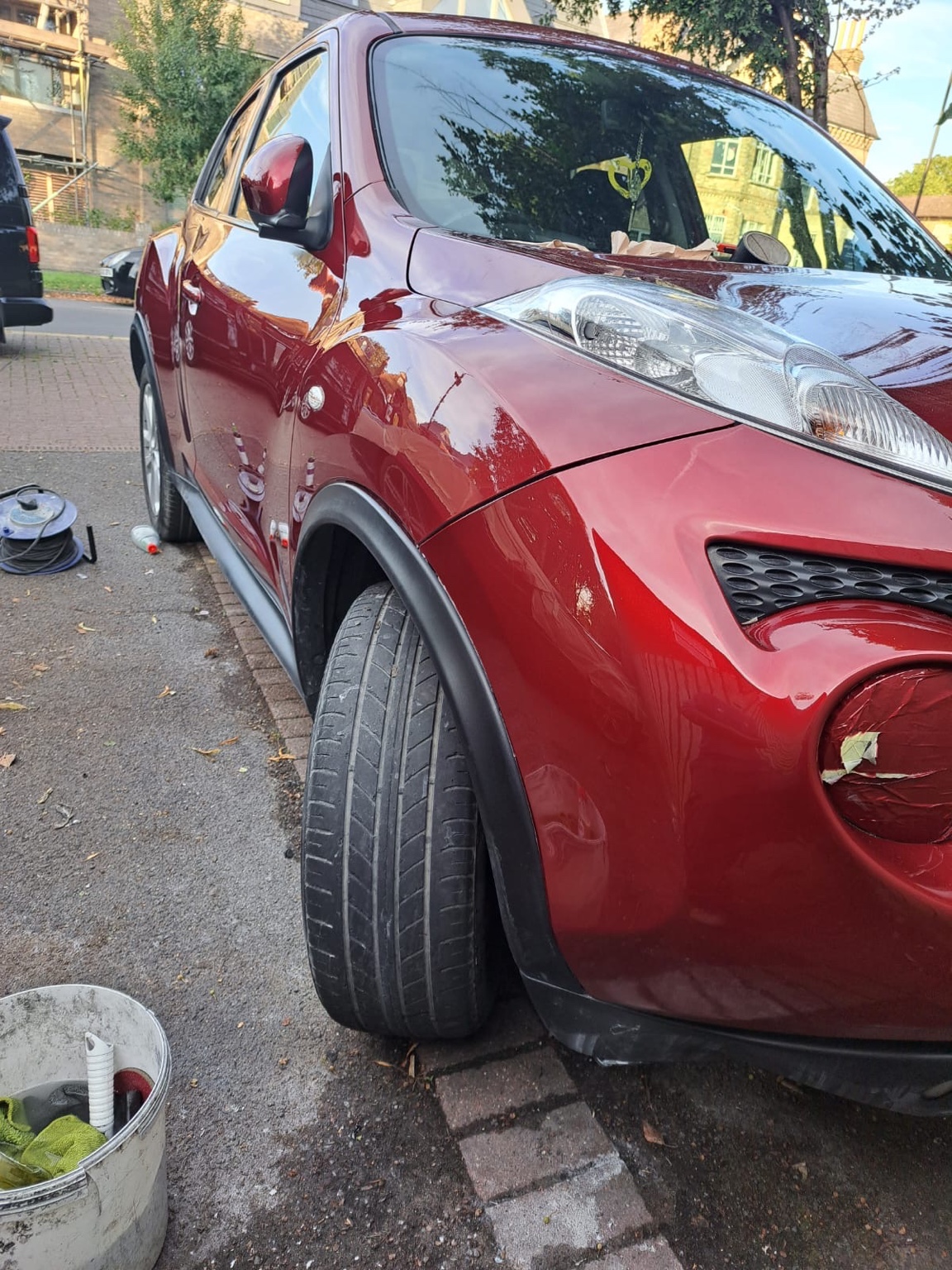 Red car side panel after glossy finished repair